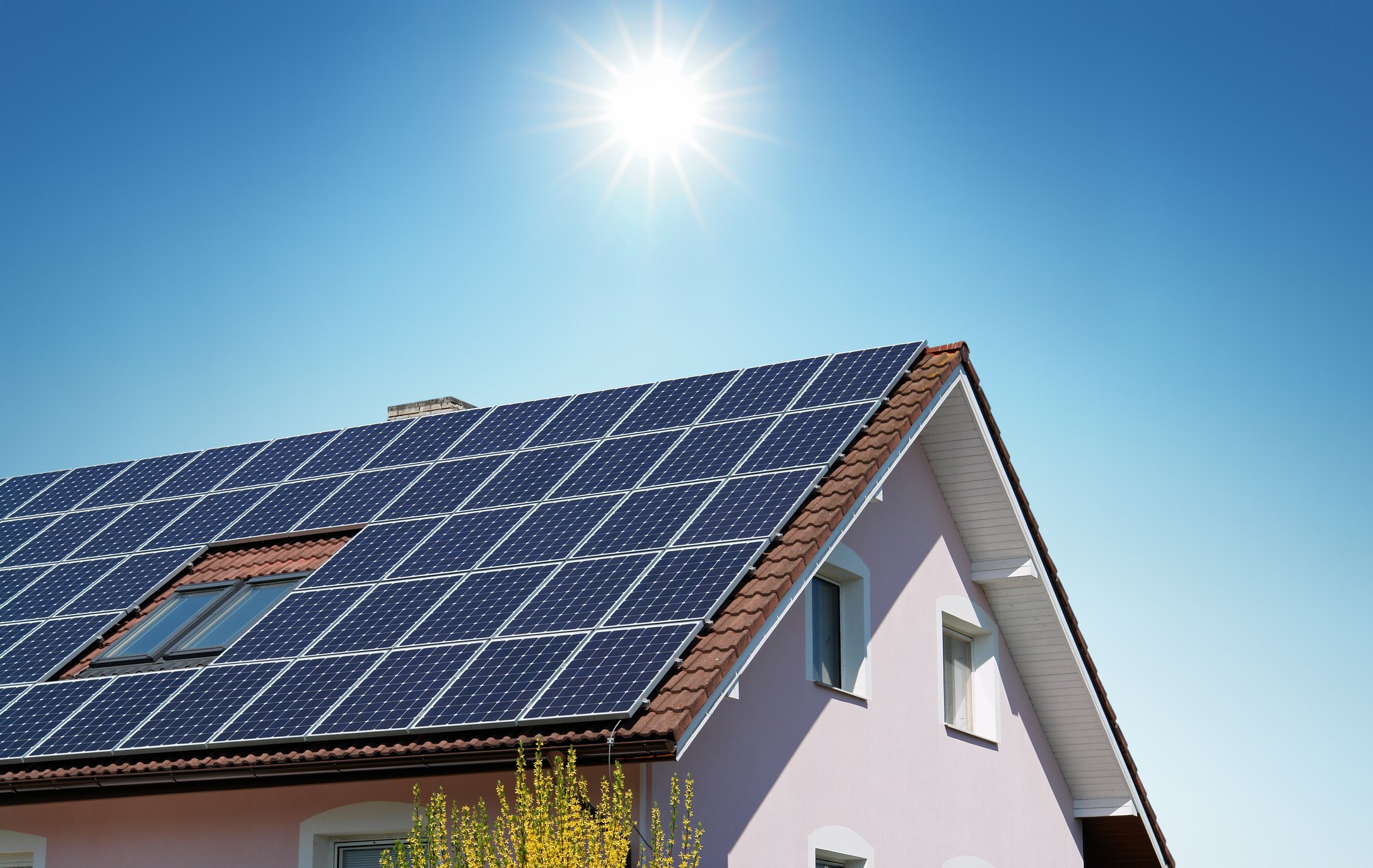 Large pitched house roof covered in solar panels