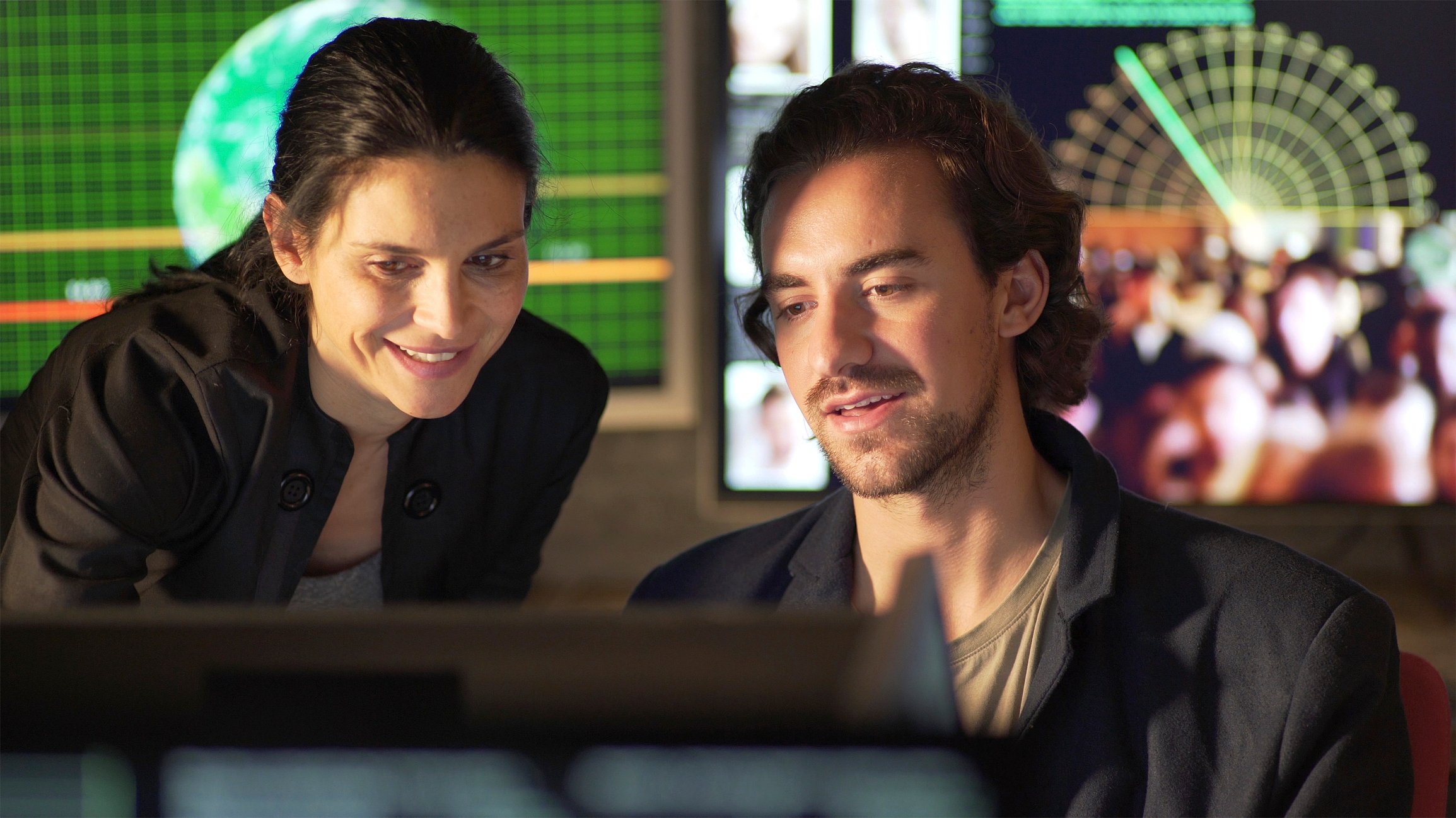 Two people looking at computer screen