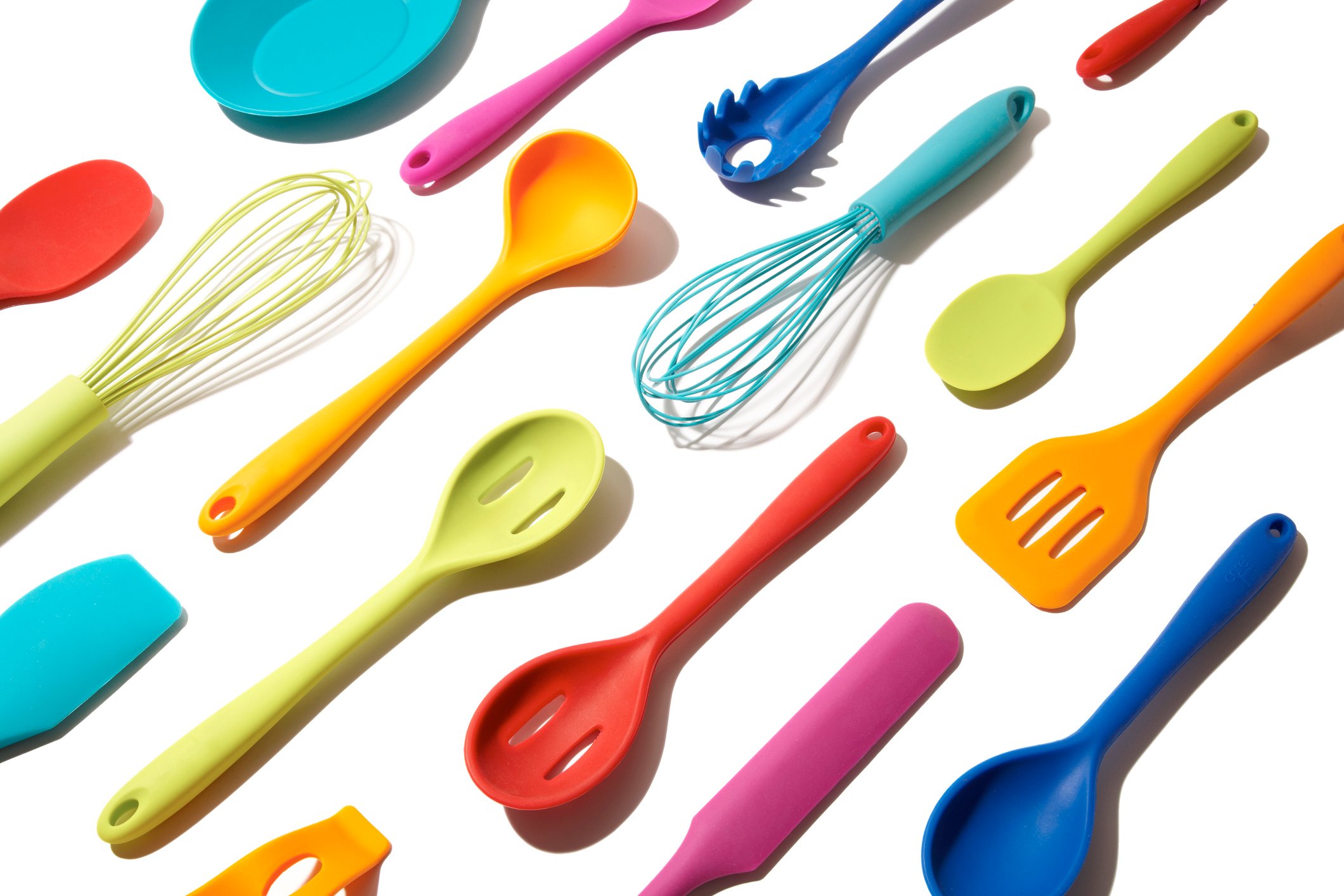 Kitchen utensils on a white surface. 