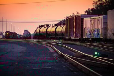 A freight train in a rail yard at dusk.