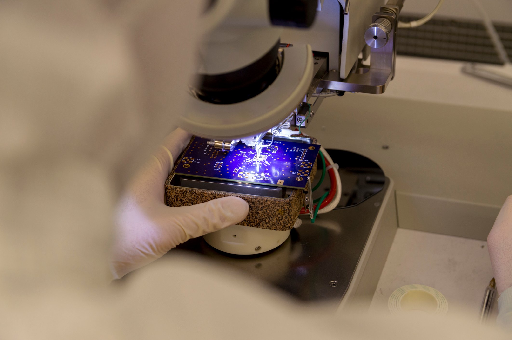 A wire bonder attaches chips to a circuit board. 