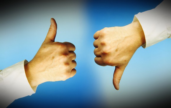 One thumb up and another thumb down