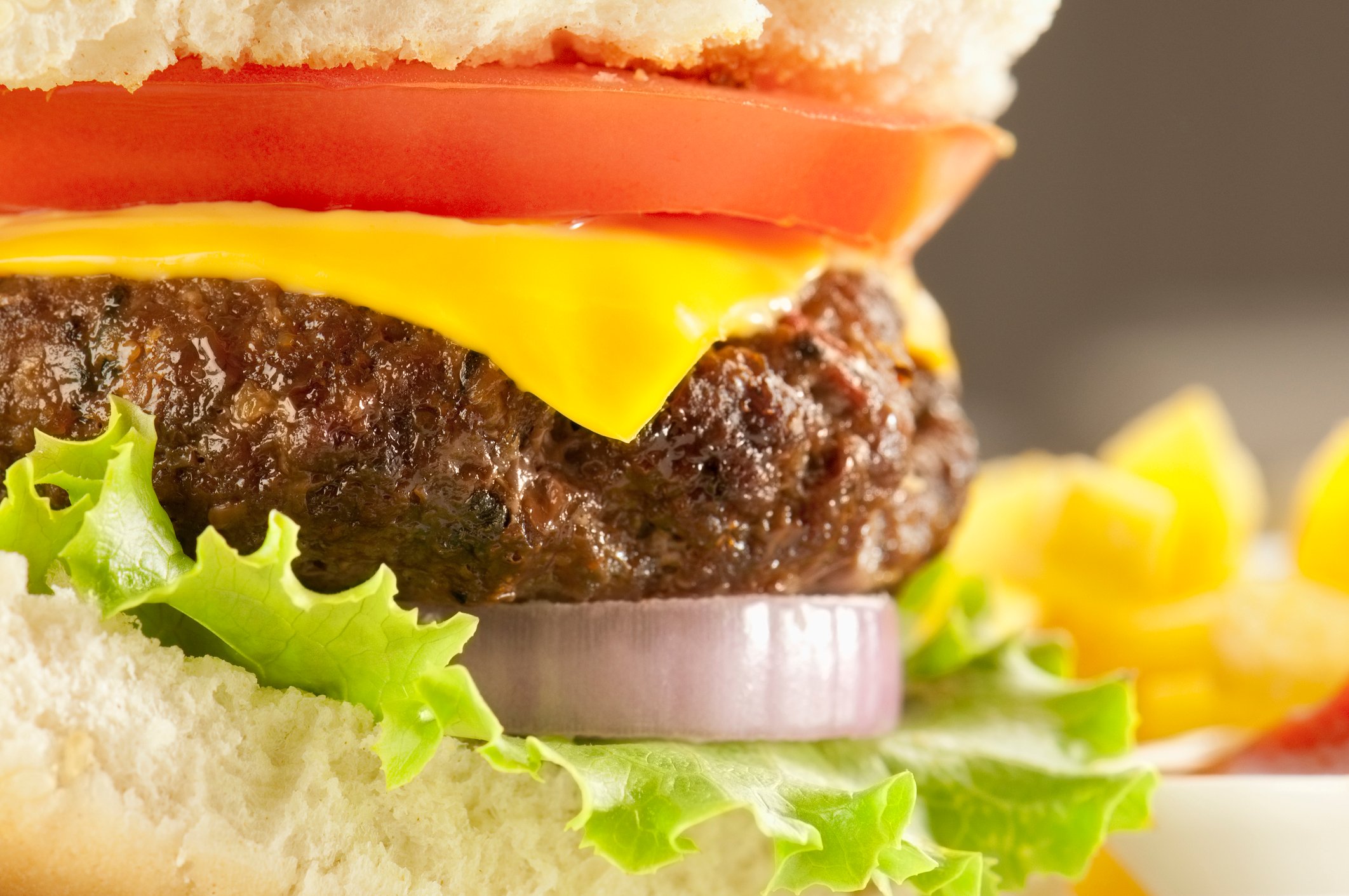 Close-up of a cheeseburger with lettuce and tomato