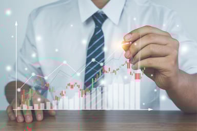 A businessman creates a digital financial chart.