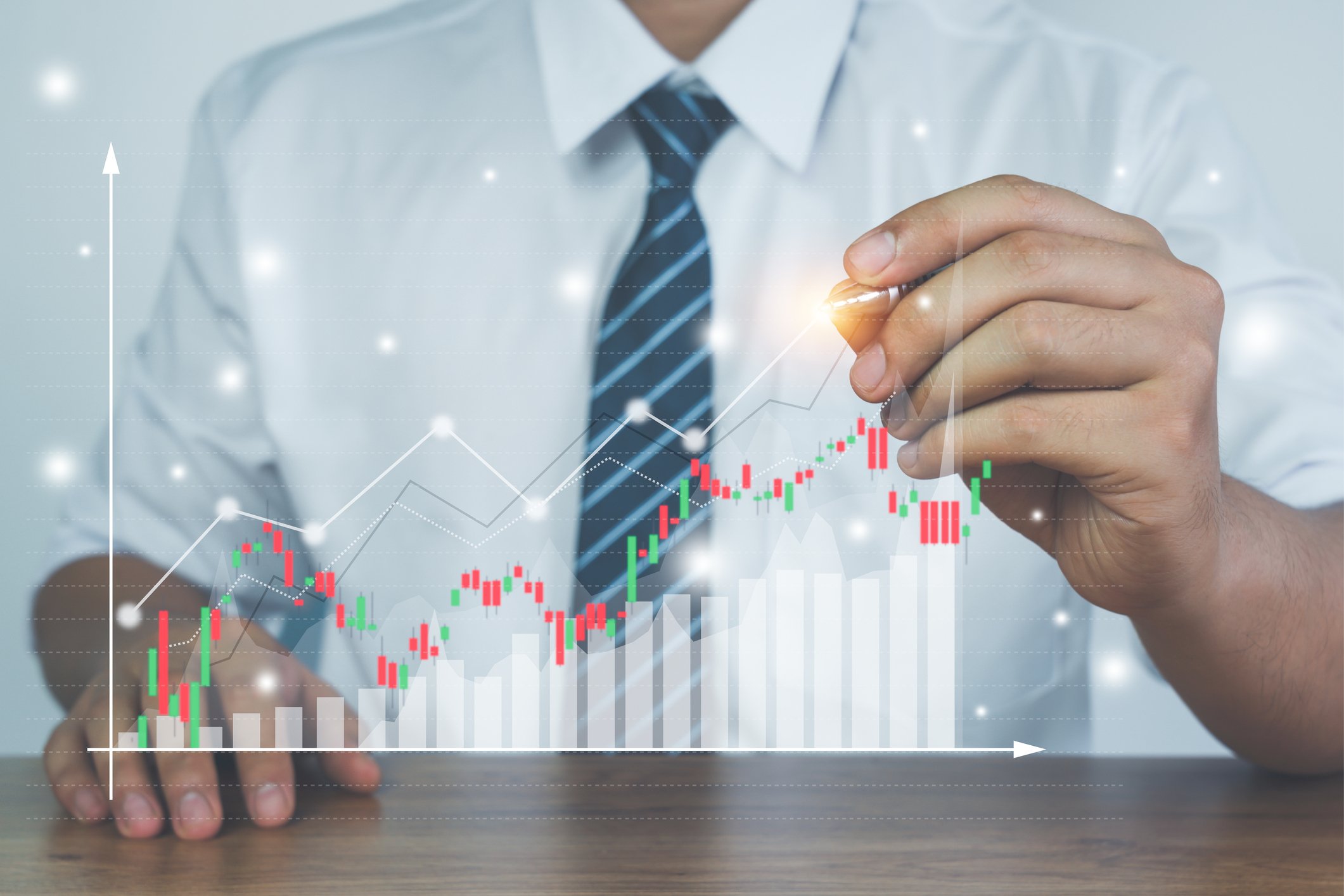 A businessman creates a digital financial chart.