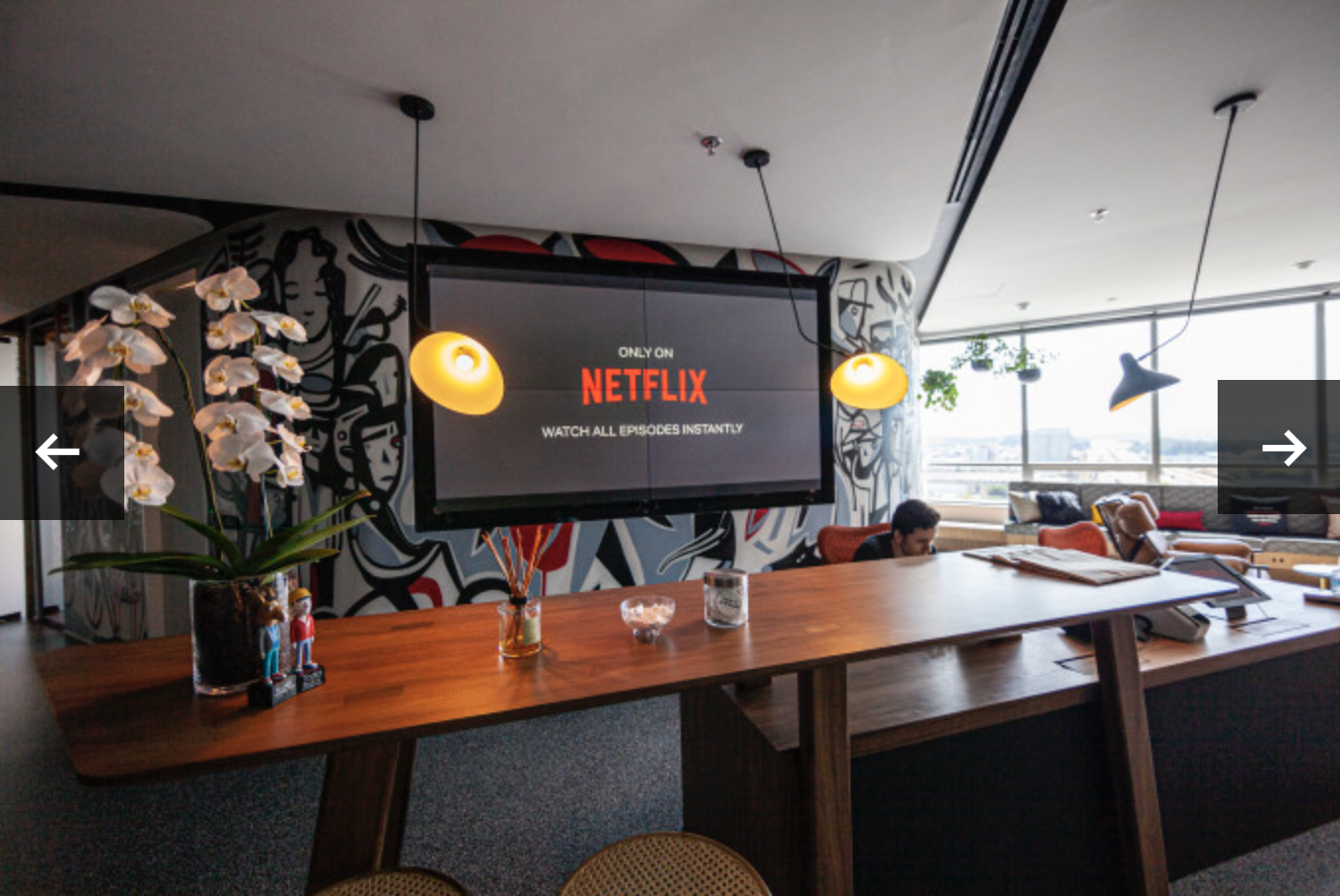 Netflix logo displayed on a large TV screen.
