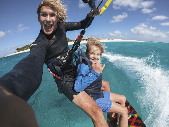 wind surfer with little brother taking action camera footage