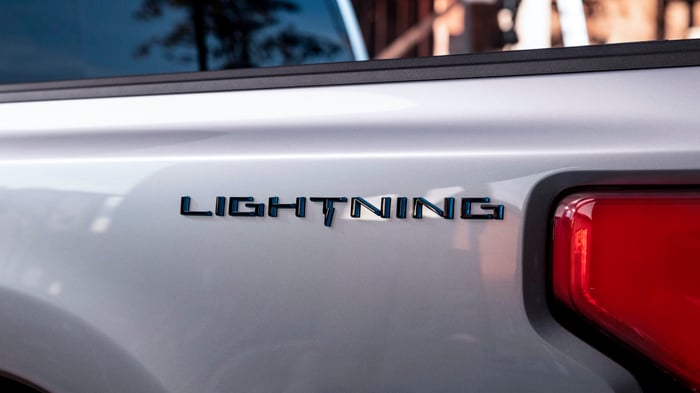 A "teaser" image showing the Lightning logo on a Ford pickup truck's flank. 