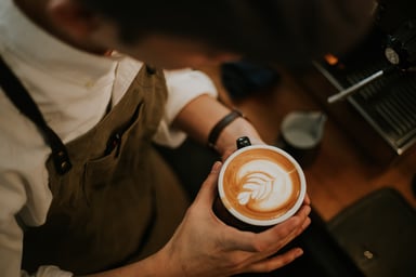 Barista Looking at Cup of Coffee