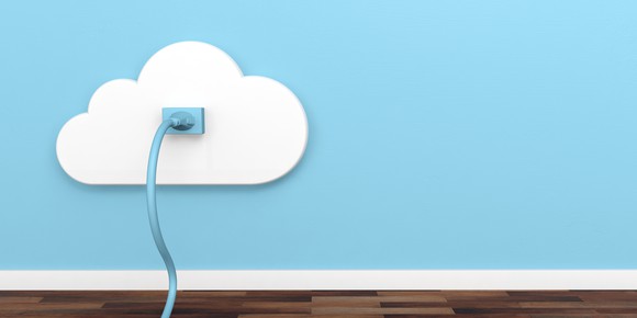 A blue network cord plugged into a cloud-shaped wall jack.