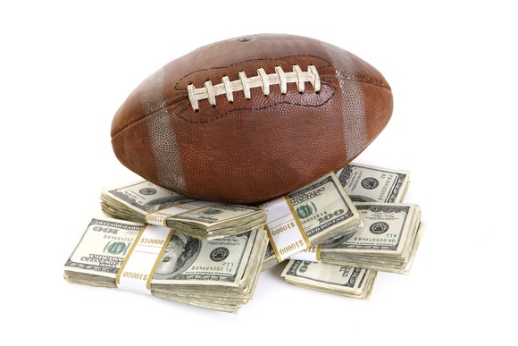 Stacks of money with a football on top