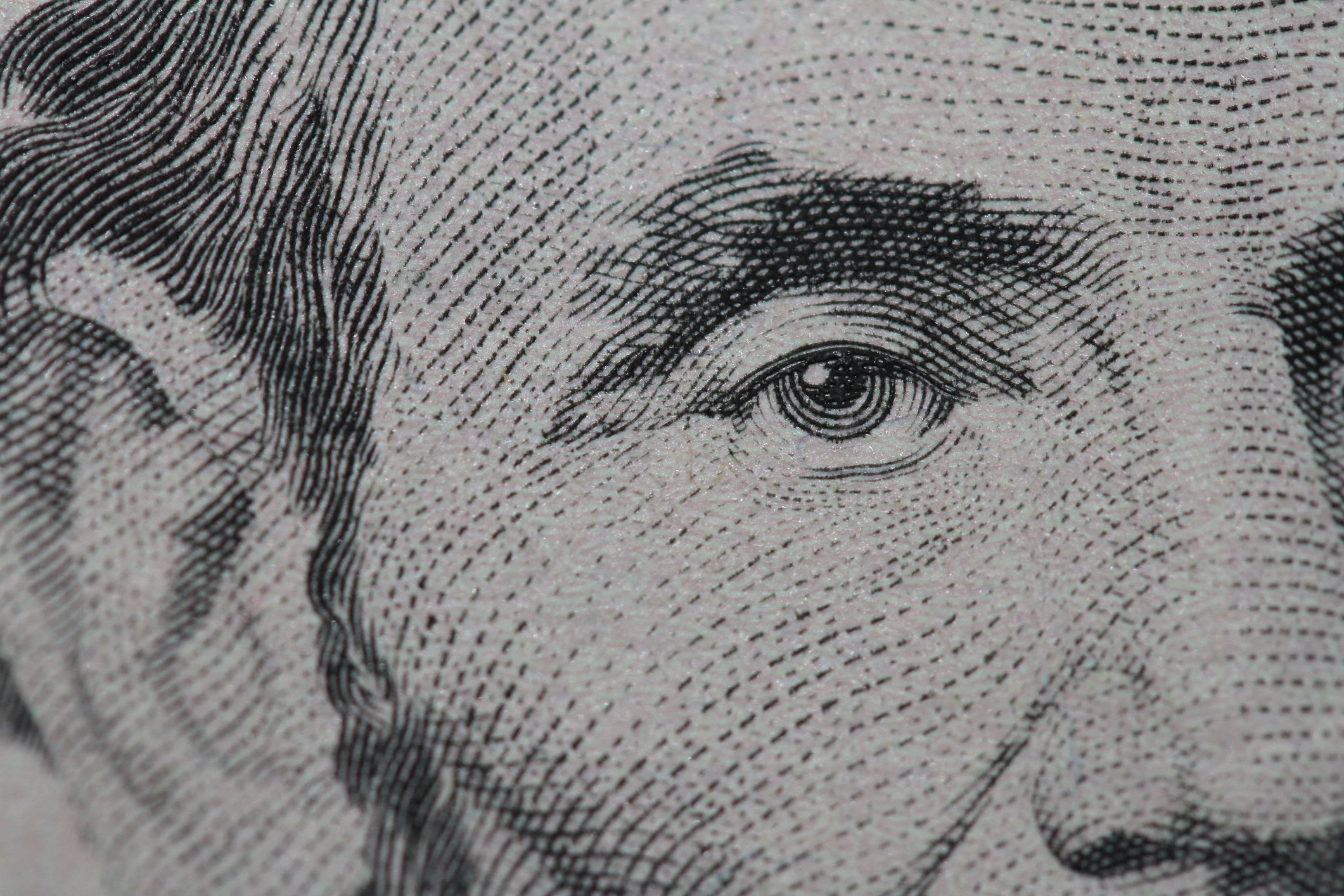 A close up of Abraham Lincoln's face on the $5 bill. 
