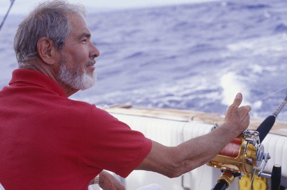 A man fishes from his boat