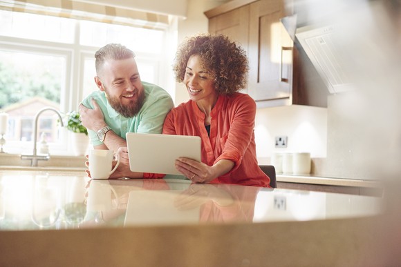 A man and woman go over their finances at the table.