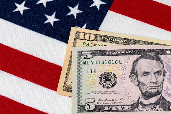 $5 and $10 bill on American flag