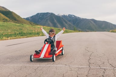 young boy in suit wins go cart race