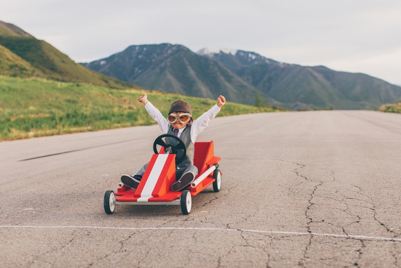 Young boy in a suit wins a go cart race