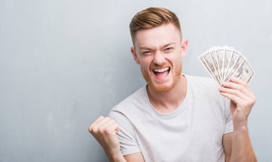 man-holding-50-dollar-bills