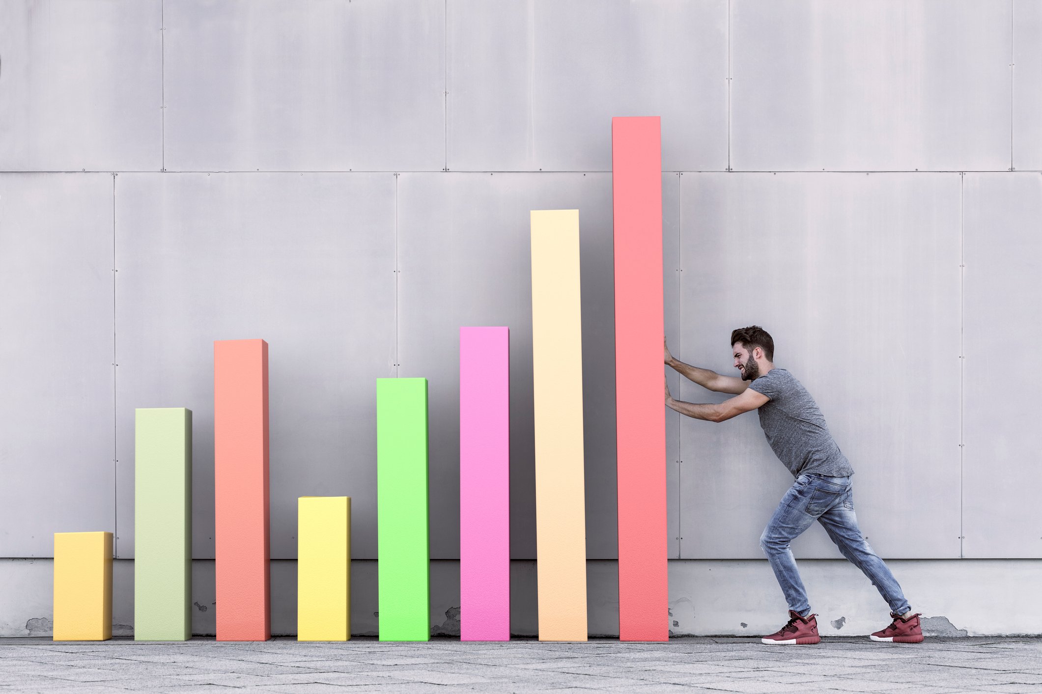 Man lining up rectangles to form bar graph
