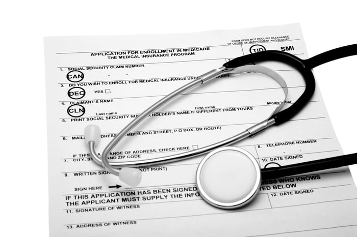 Stethoscope over Medicare enrollment form.