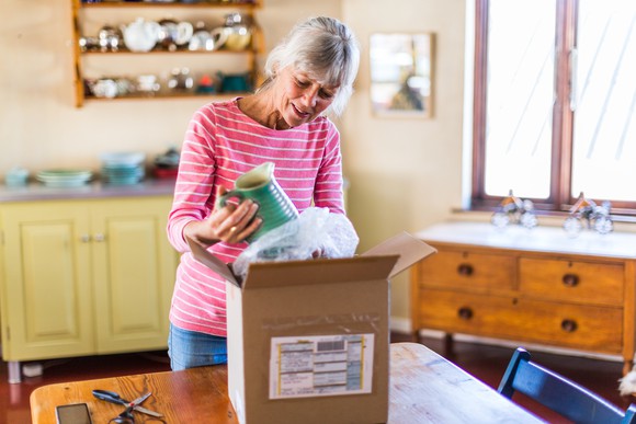 A person opens up a box that contains a product ordered online.