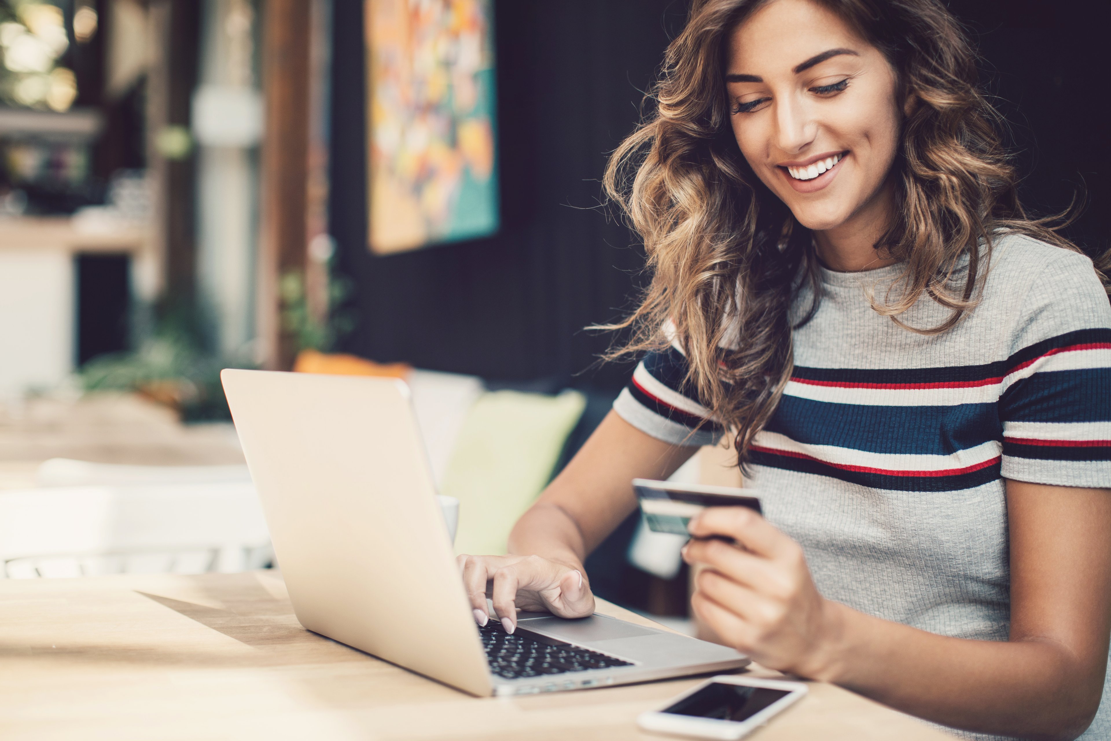 Woman buying item on laptop with credit card.