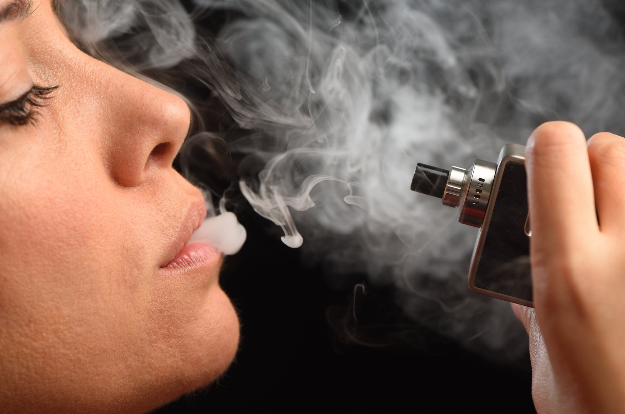 Young woman smoking an e-cigarette.