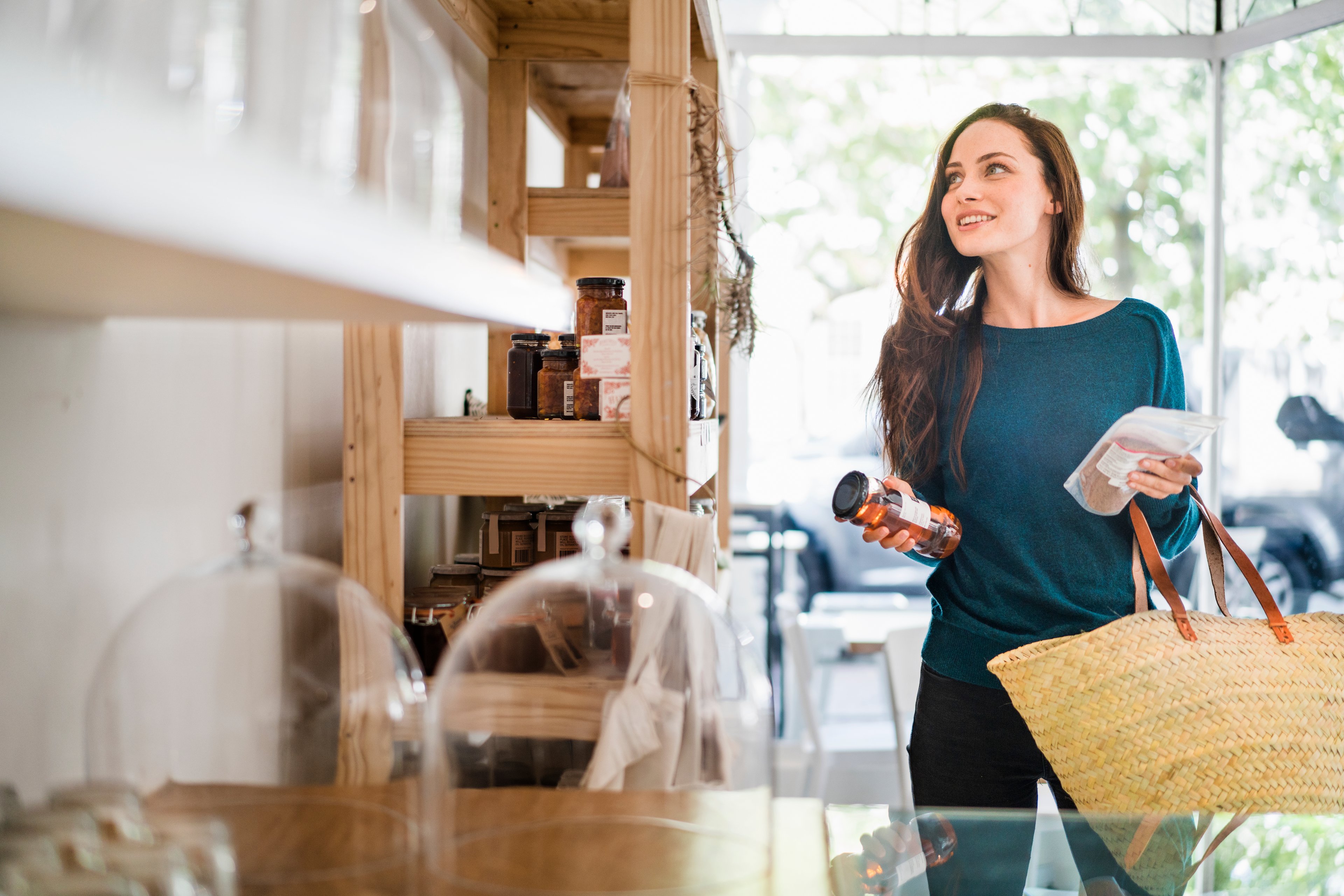 Person in a store with a shopping basket. 
