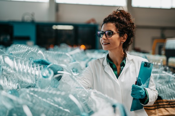 A woman inspecting plastic jugs