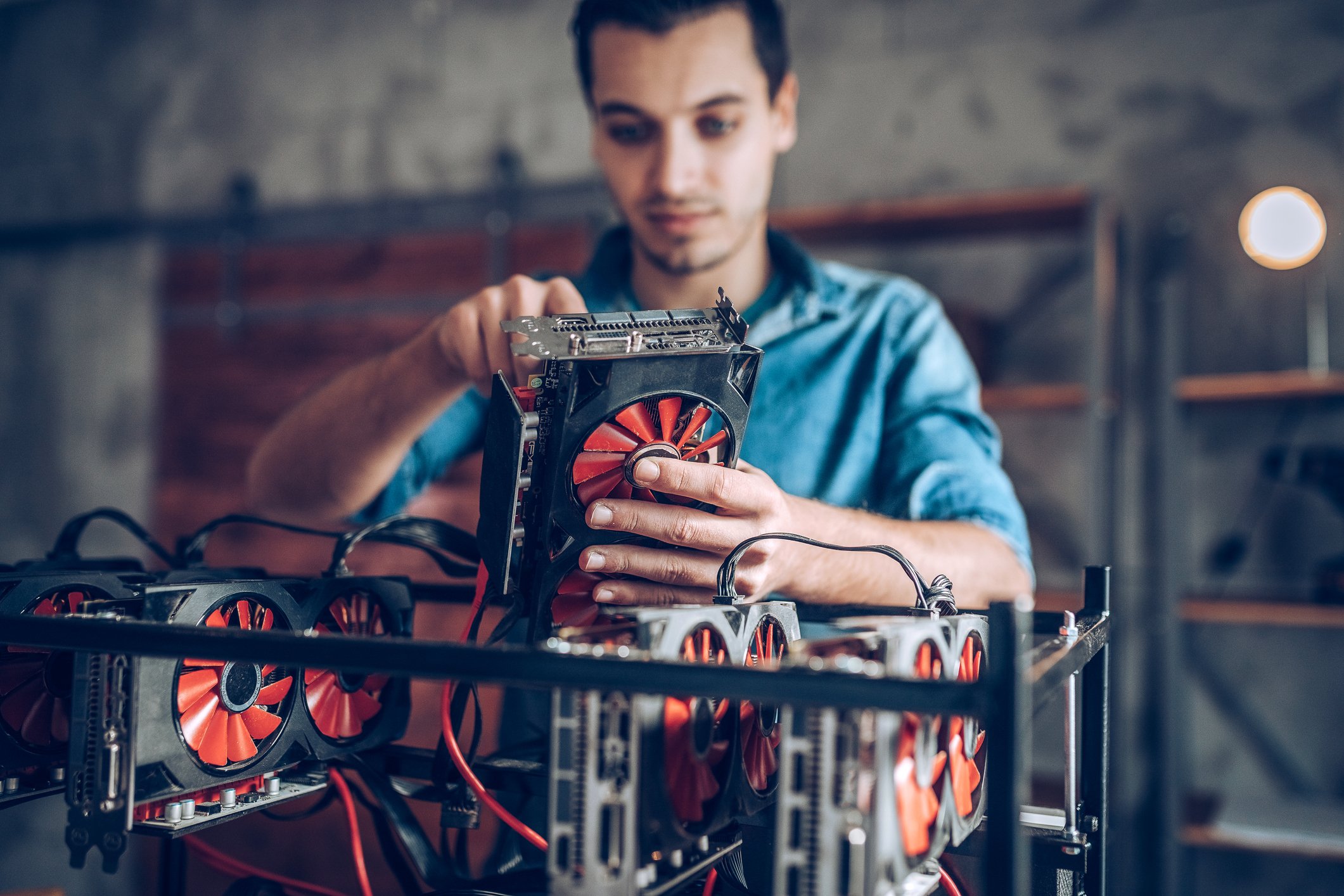 A man sets up a cryptocurrency mining rig.