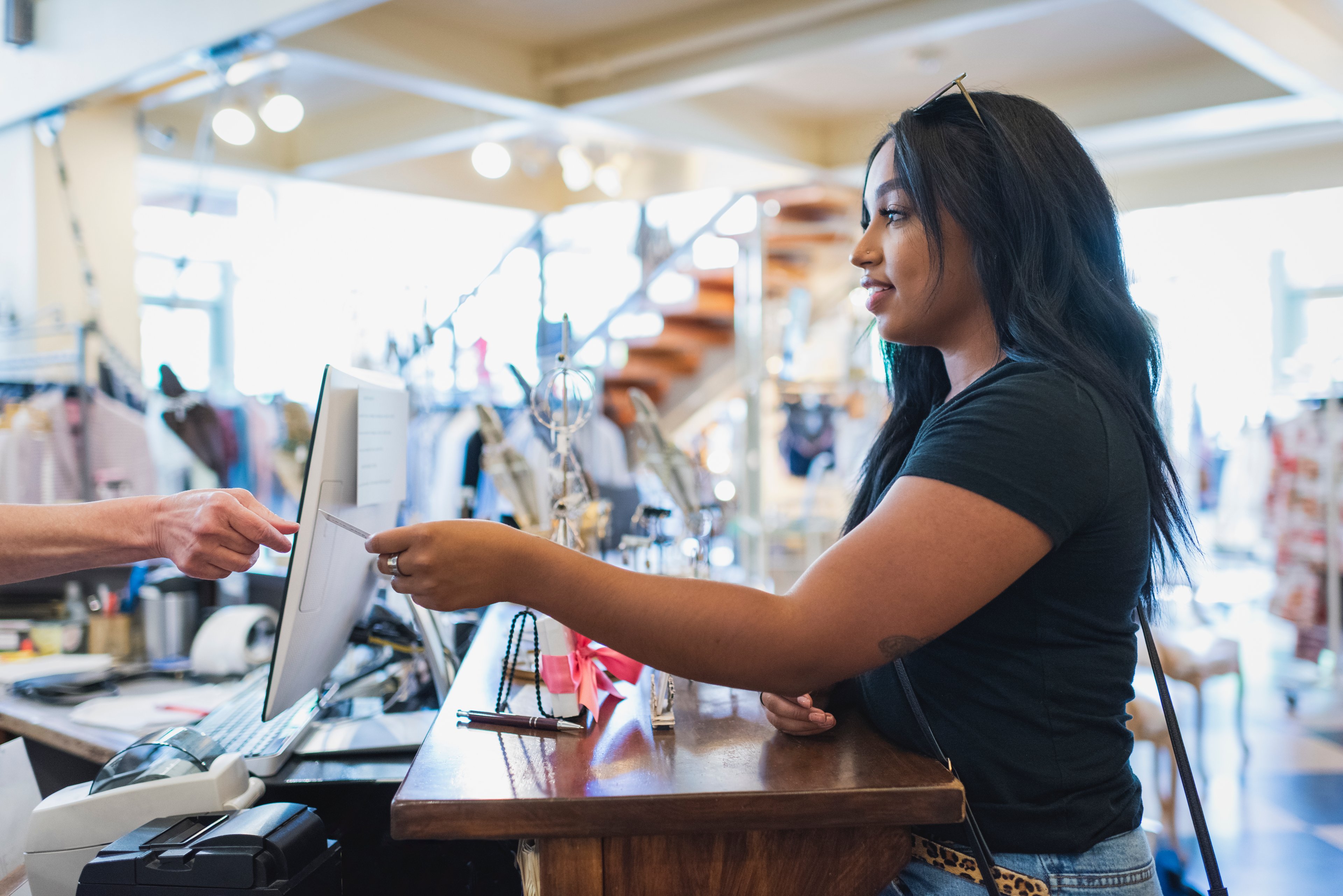 A woman makes a purchase at a high-end retailer.