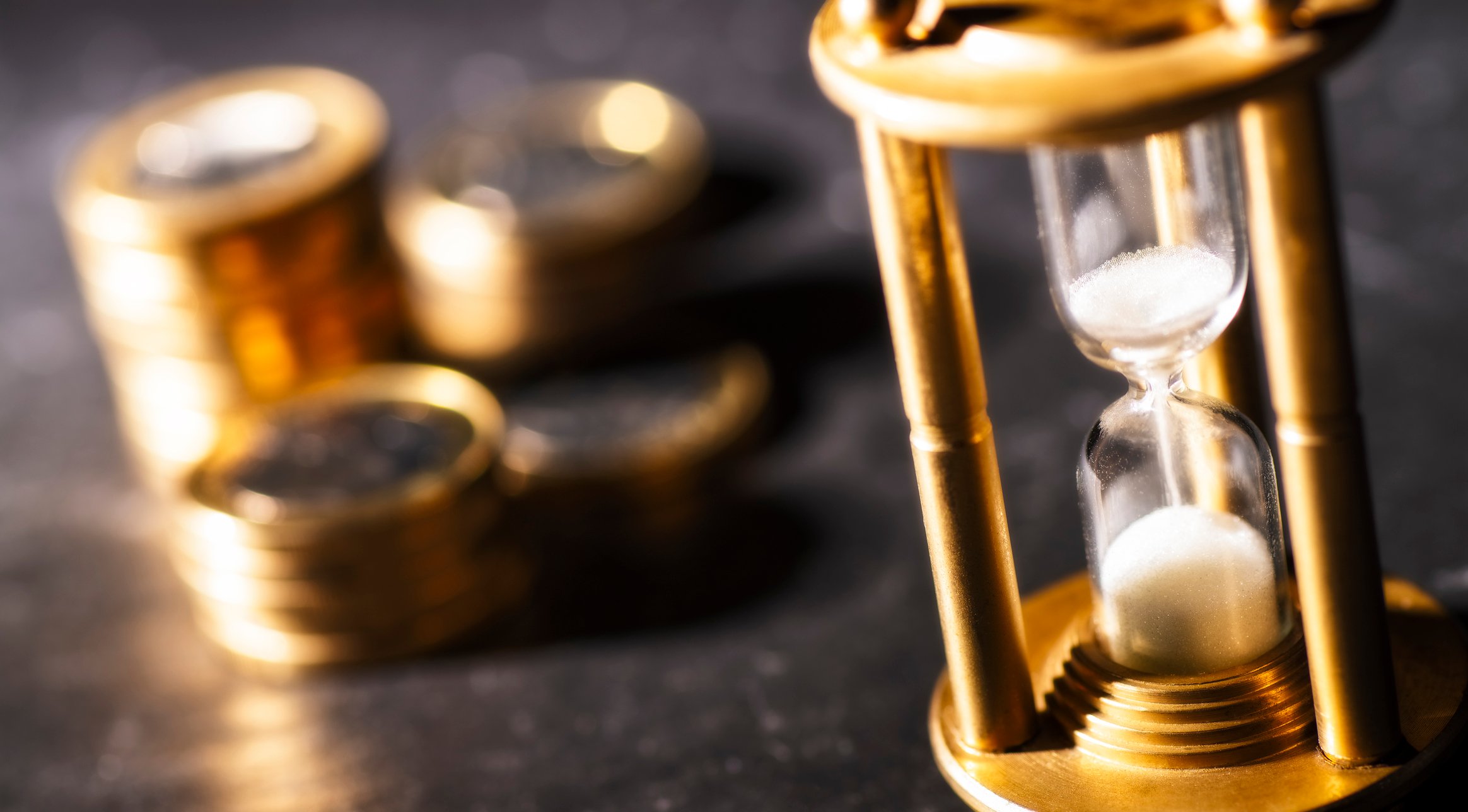 Stacks of coins and an hour glass.
