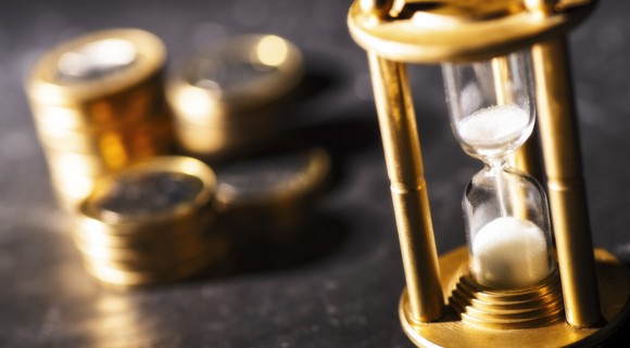 Stacks of coins and an hour glass.
