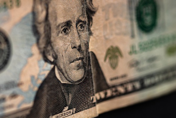 a closeup view shows Andrew Jackson's profile from the $20 bill. Twenty-dollar bill
