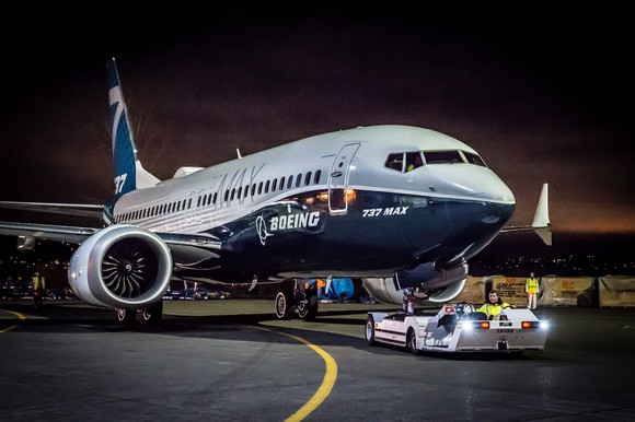 A Boeing 737 MAX being pulled toward a gate.