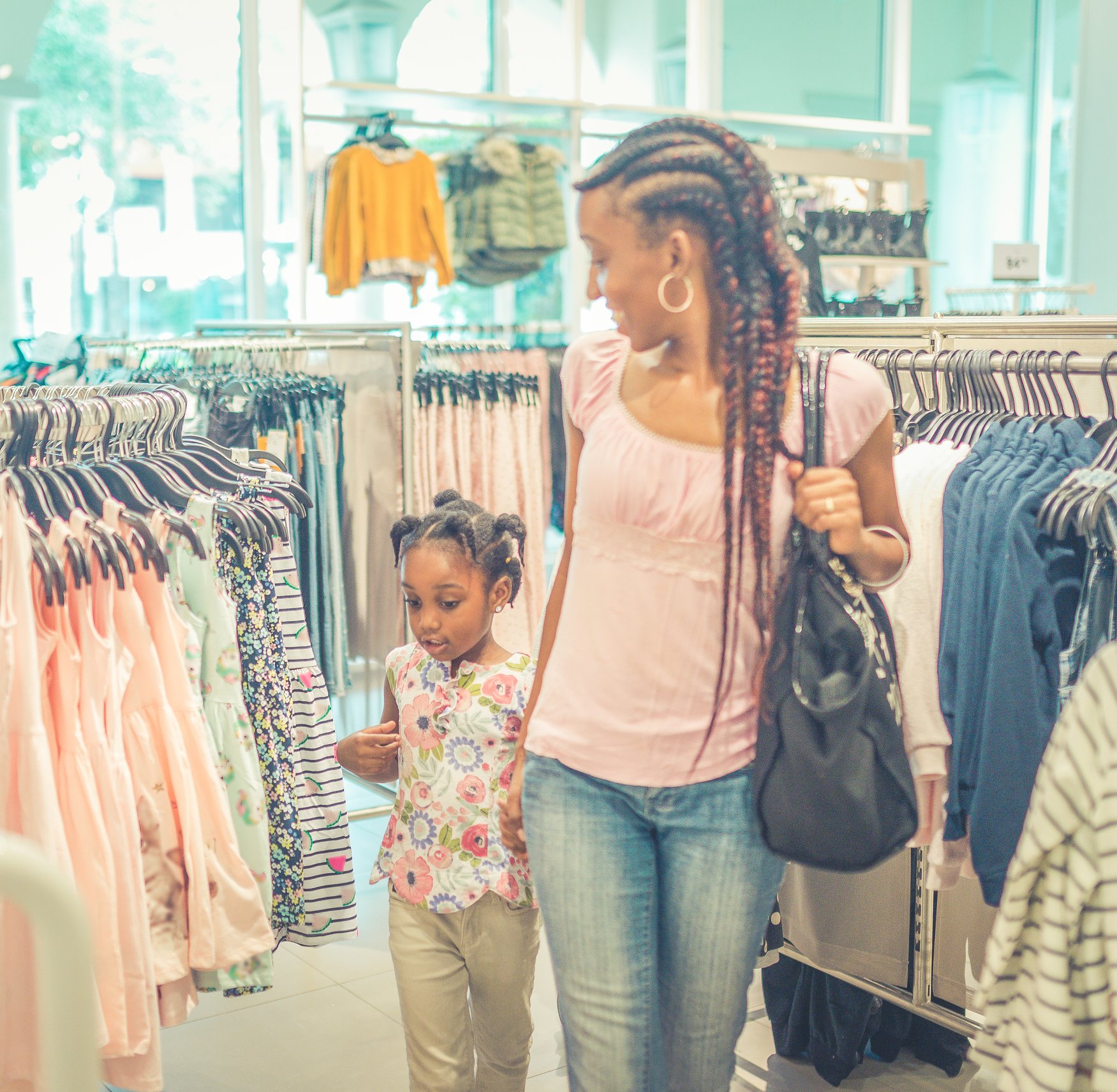 A mom and daughter shopping for clothes together