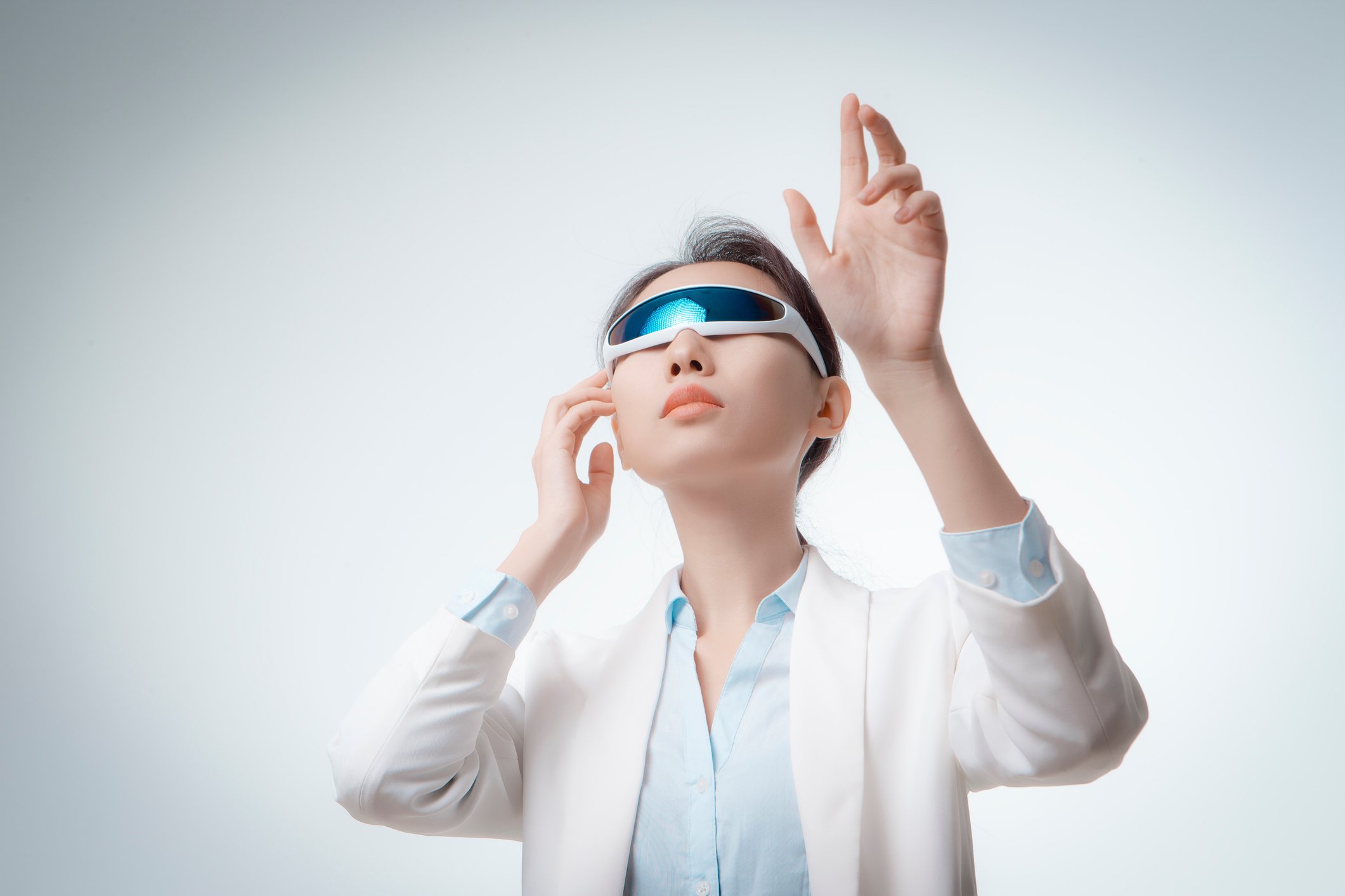 Young person wearing augmented reality glasses while enjoying an AR experience.