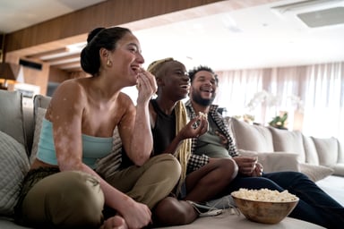 Diverse friends watching TV together