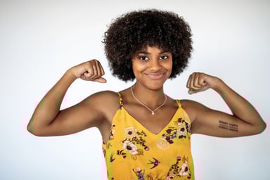 A woman flexes her biceps.