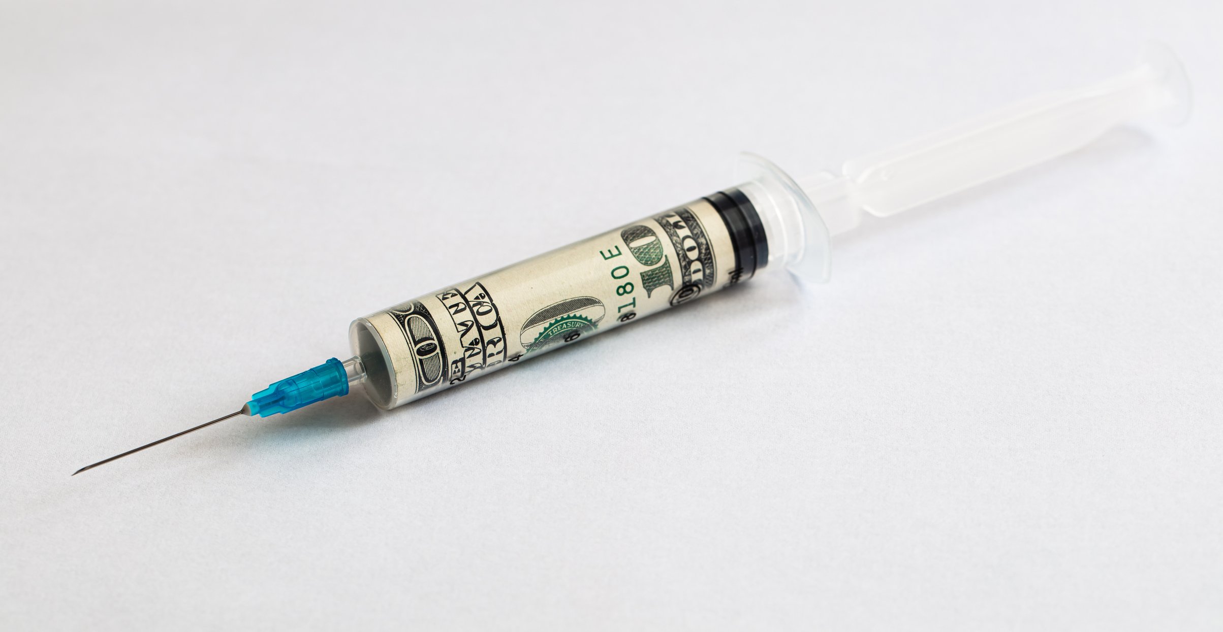 A vaccine syringe with $100 bill rolled up inside it.