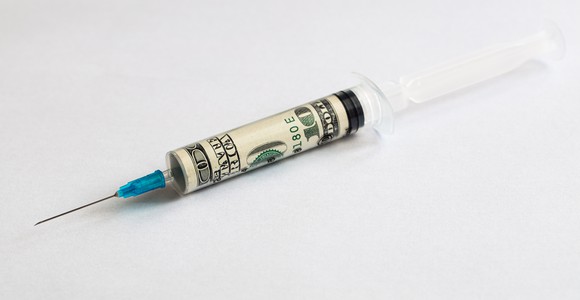 A vaccine syringe with $100 bill rolled up inside it.