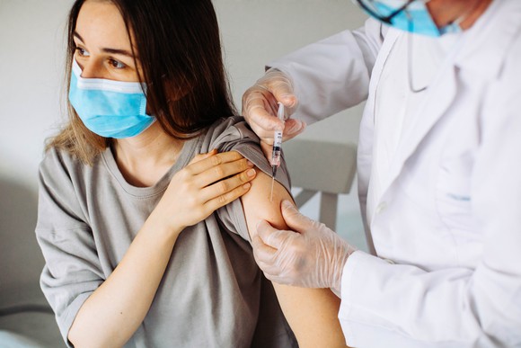 Woman receiving coronavirus vaccine. 