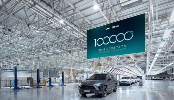 The 100,000th NIO, an ES8 SUV, is shown under a commemorative banner at an event at the factory in April. 