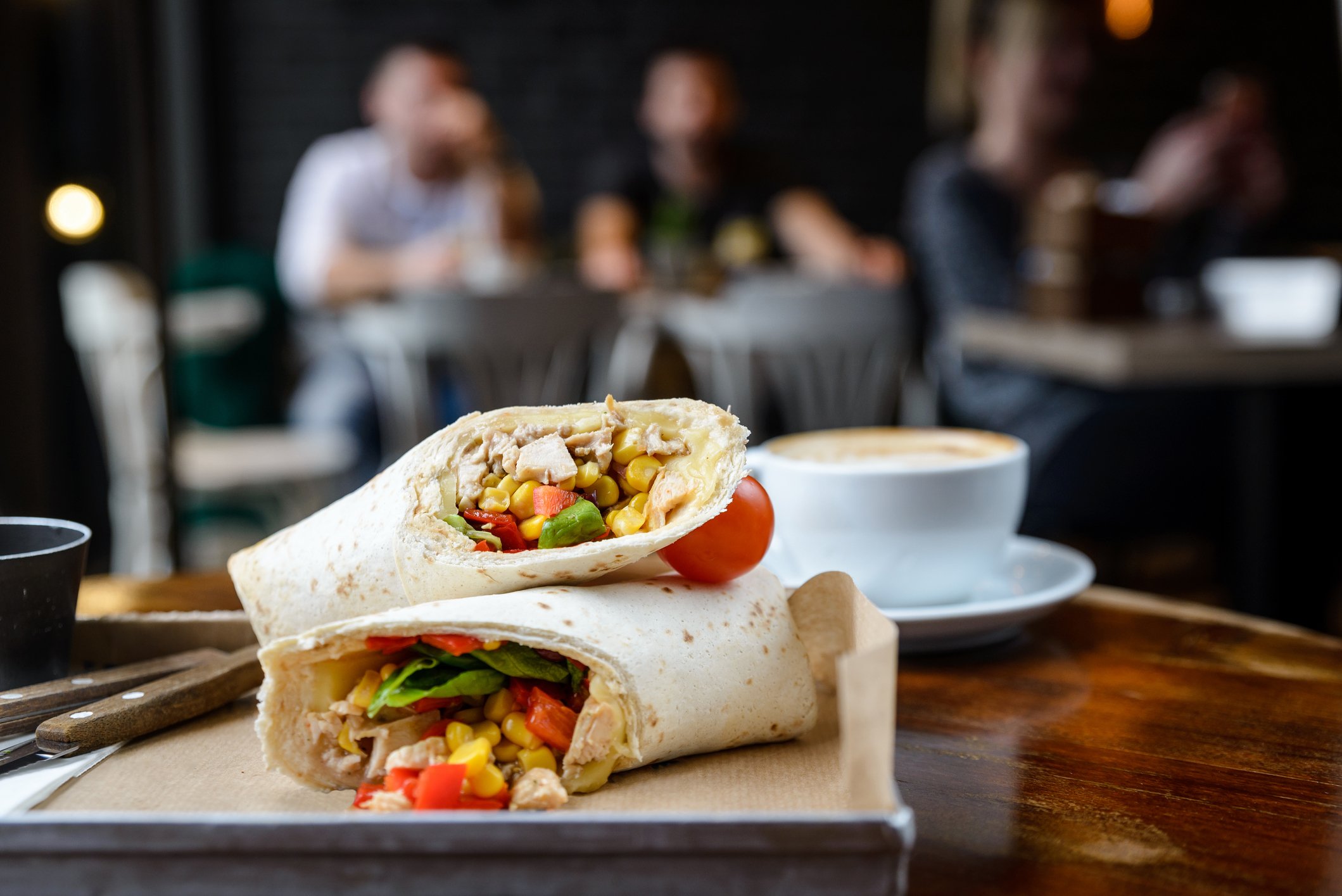 burrito and cup of coffee on a wooden table