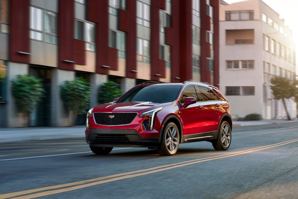 A 2021 Cadillac XT4 driving down a city street.