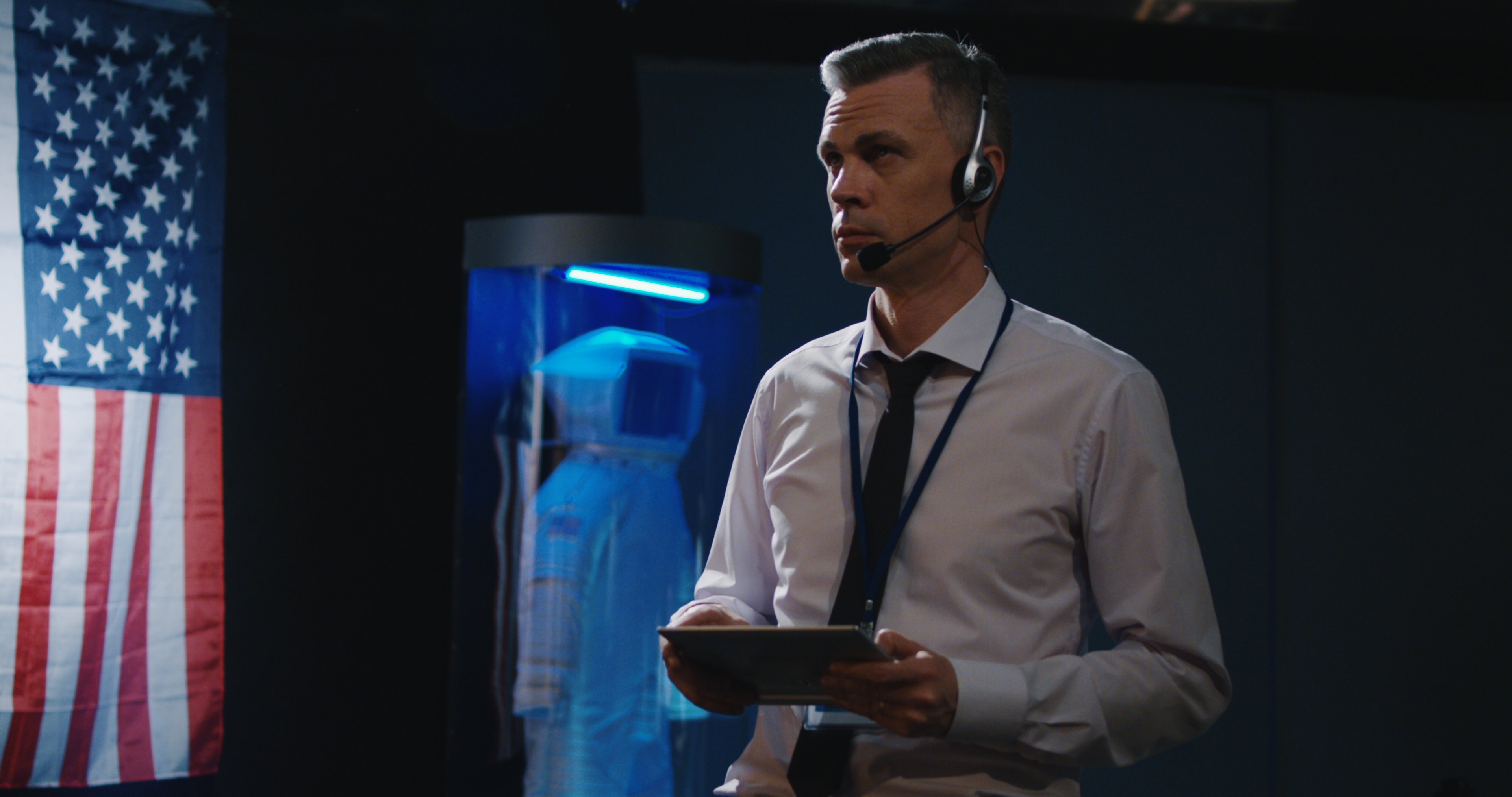 A mission control operator monitors a mission from a tablet.