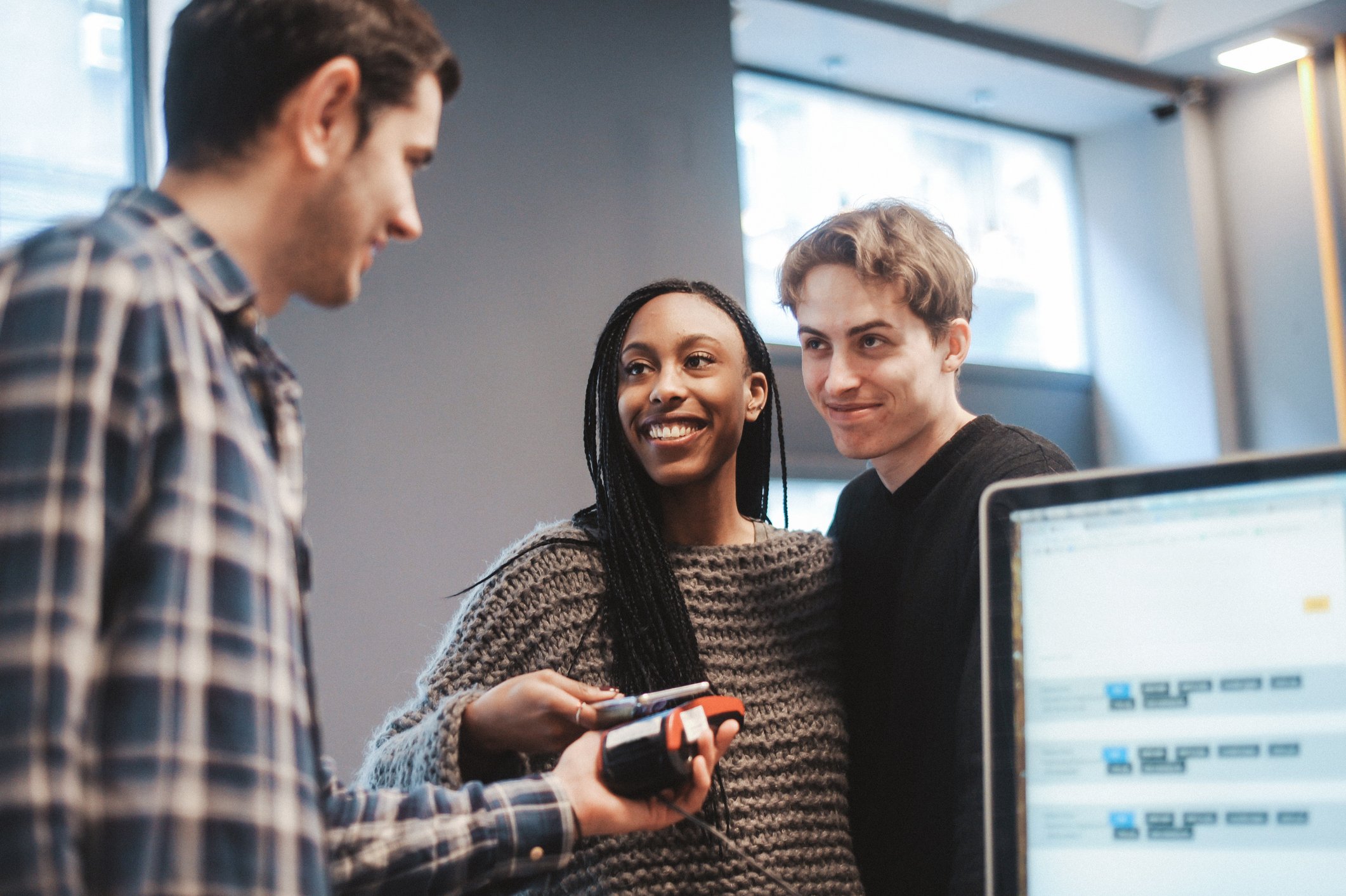 Man and woman making contactless payment on a payment terminal