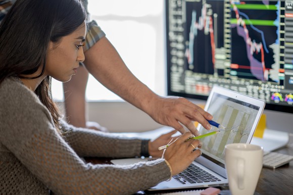 An investor reviewing a chart on a computer.