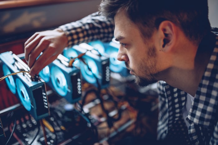 Person working on a cryptocurrency mining rig.