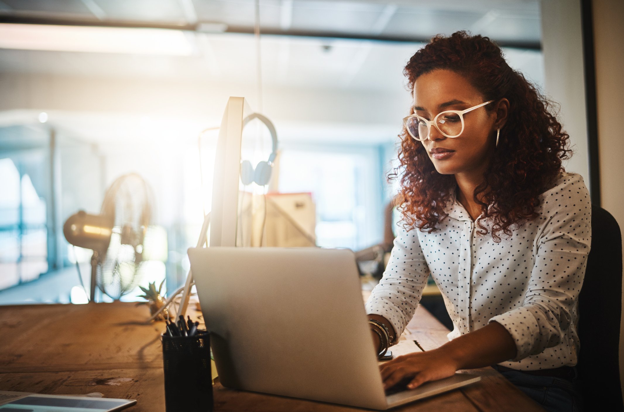 Woman typing at a computer.